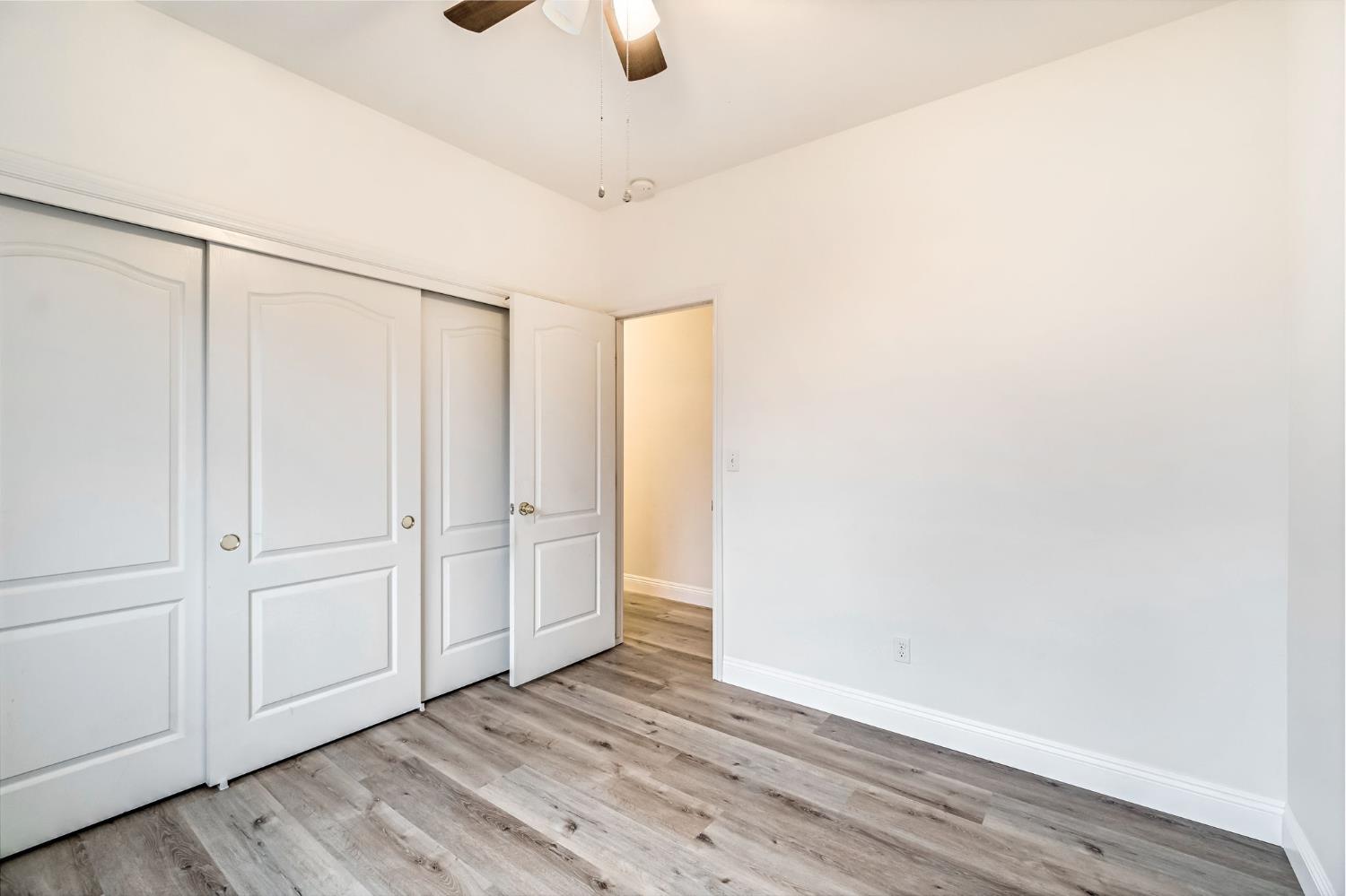2095 Independence Place Hanford, CA 93230 - Photo 16 of 35 a view of an empty room with wooden floor