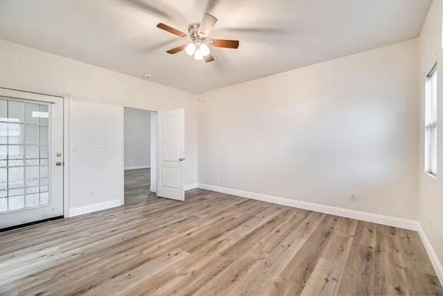 wooden floor in an empty room with a window
