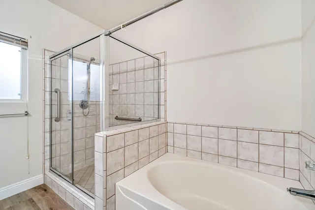 a bathroom with a bathtub and shower