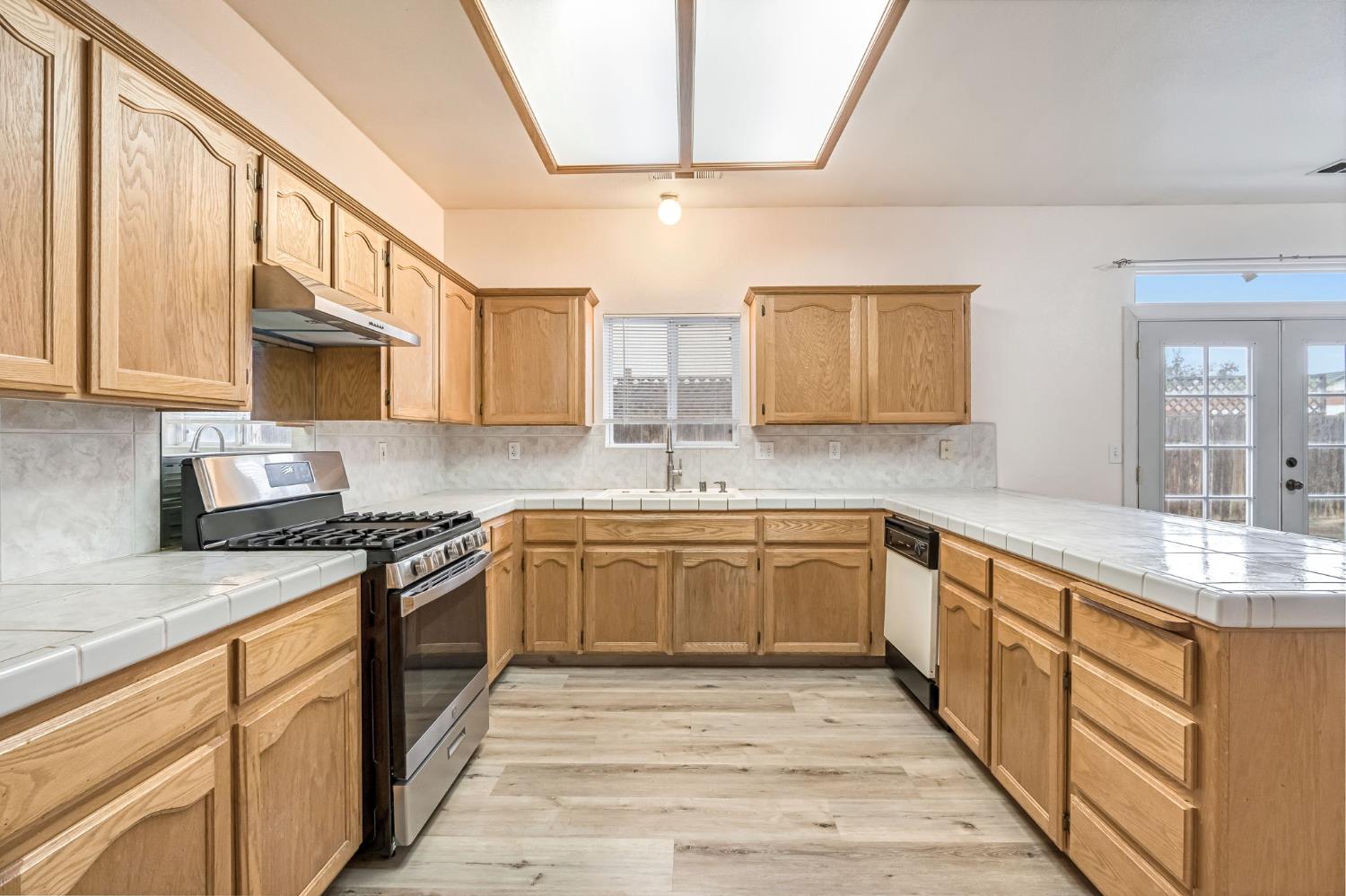 2095 Independence Place Hanford, CA 93230 - Photo 29 of 35 a large kitchen with stainless steel appliances granite countertop a stove sink and cabinets