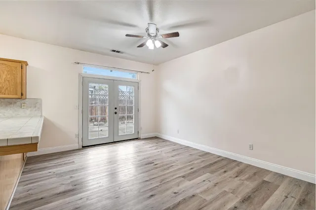 wooden floor in an empty room with a window