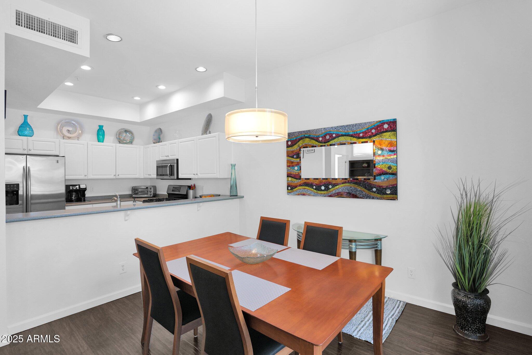 8270 North Hayden Road, Unit 2013 Scottsdale, AZ 85258 - Photo 10 of 53 a kitchen with a table and chairs in it