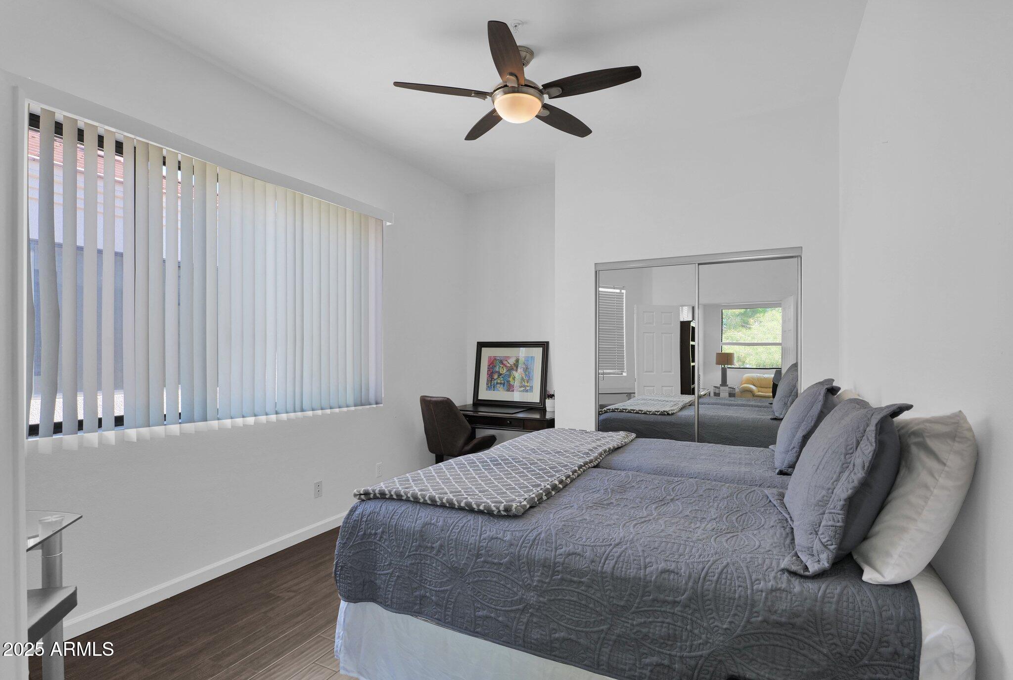 8270 North Hayden Road, Unit 2013 Scottsdale, AZ 85258 - Photo 17 of 53 a bedroom with a bed and a chandelier