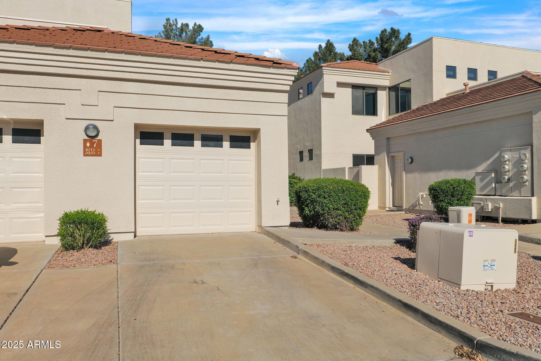 8270 North Hayden Road, Unit 2013 Scottsdale, AZ 85258 - Photo 39 of 53 a view of a house with a yard and potted plants