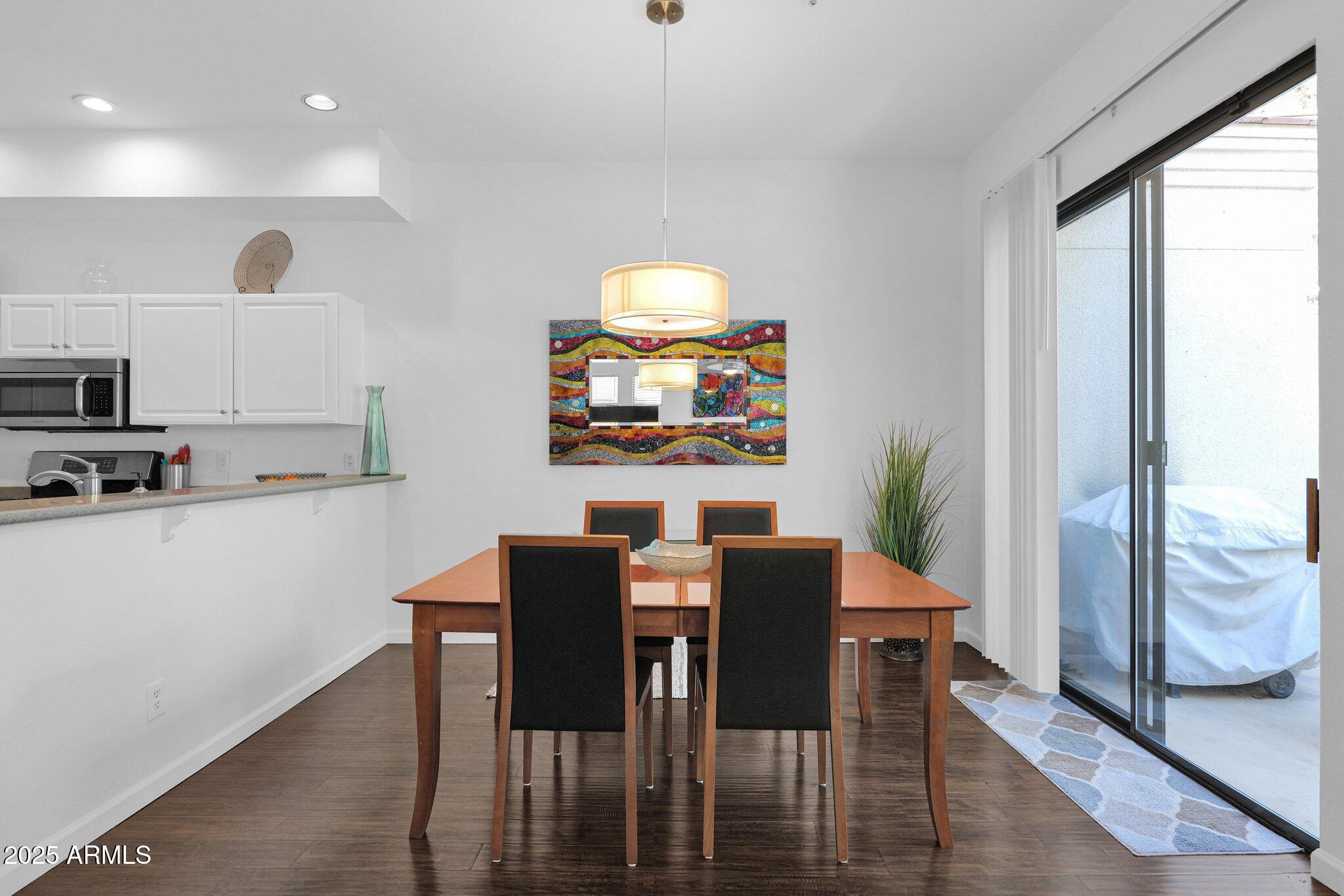 8270 North Hayden Road, Unit 2013 Scottsdale, AZ 85258 - Photo 9 of 53 a view of a dining room with furniture window and wooden floor