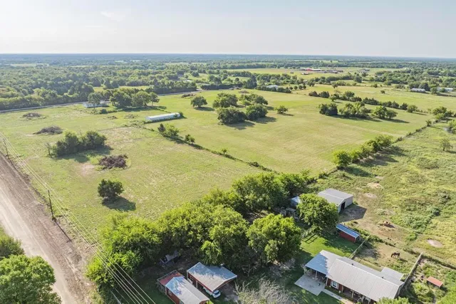 an aerial view of residential houses with outdoor space