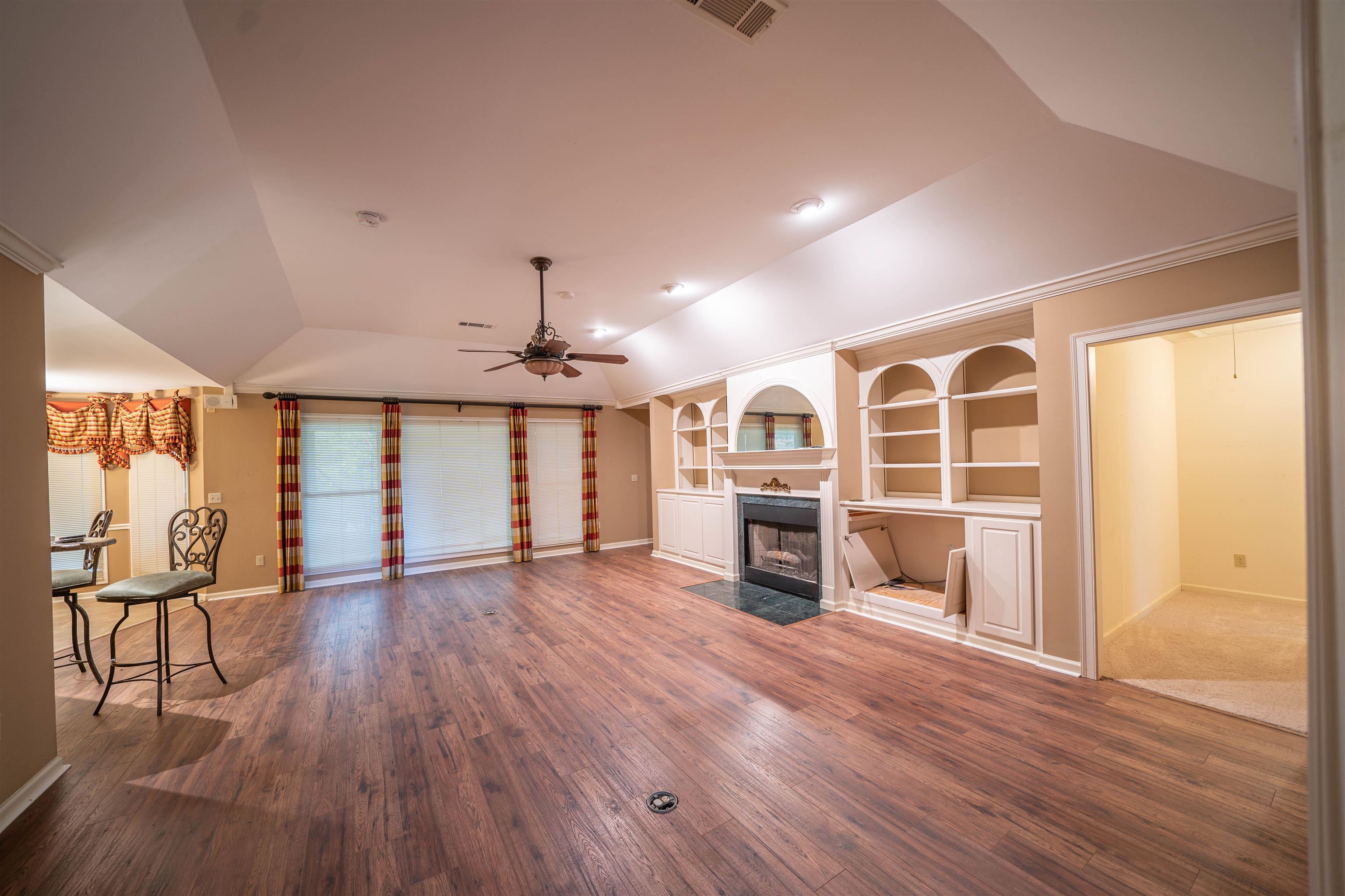 110 Fisherville Road Collierville, TN 38017 - Photo 18 of 21 an empty room with wooden floor fireplace and windows