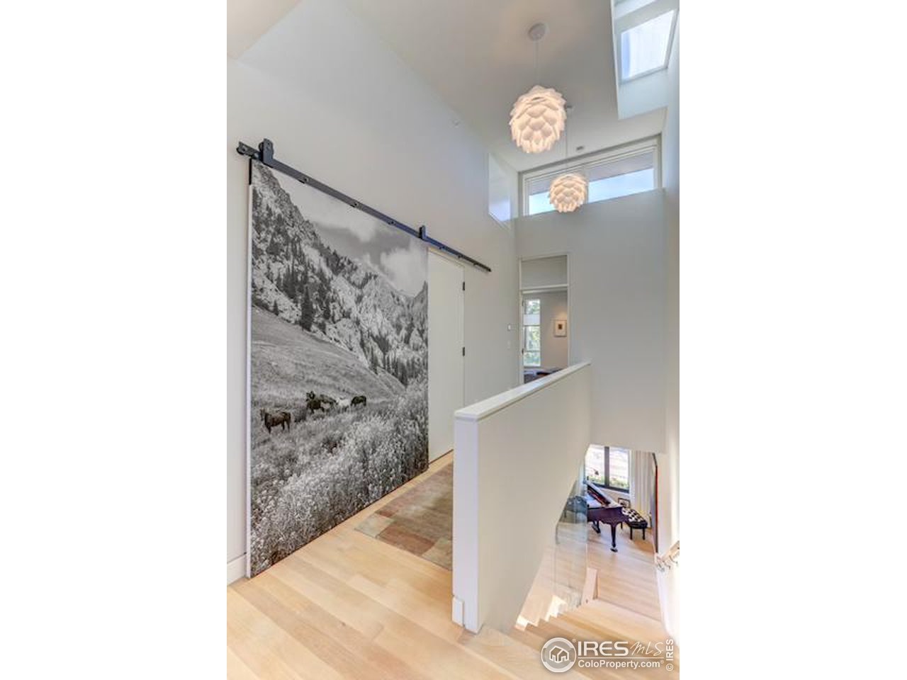 153 Mathews Street Fort Collins, CO 80524 - Photo 30 of 30 a view of a hallway with paintings on the wall