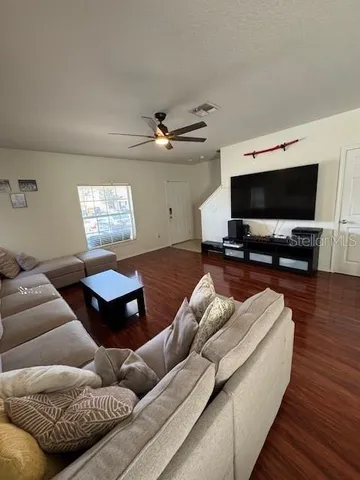 a living room with furniture and a flat screen tv