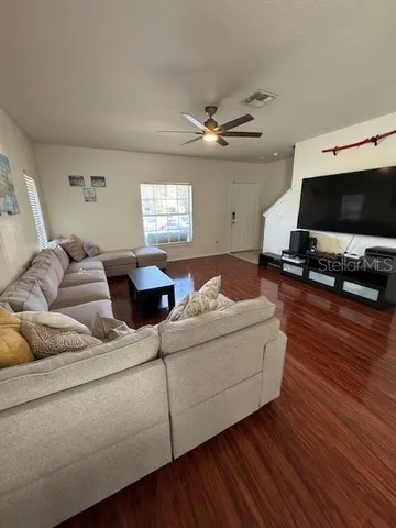 a living room with furniture and a flat screen tv