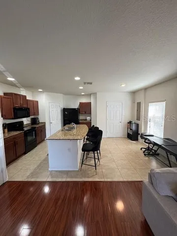 a living room with furniture and kitchen view