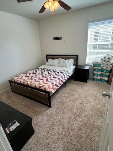 a bedroom with a bed and a couch