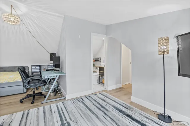 a dining room with furniture and wooden floor