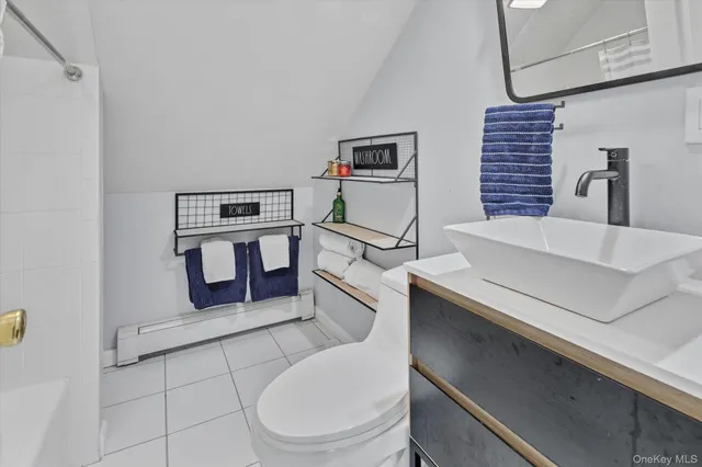 a bathroom with a sink a toilet and mirror