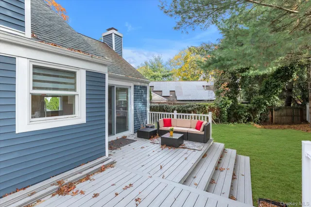 a wooden bench sitting in front of a house