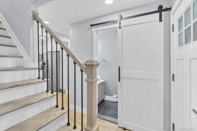 a view of entryway with wooden floor and staircase