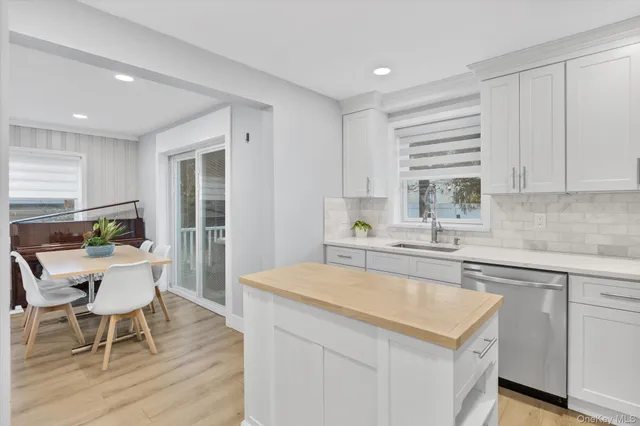 a kitchen with a stove a sink a dining table and chairs