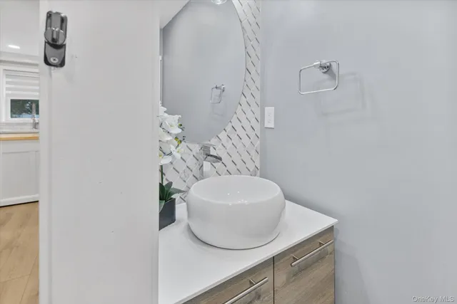 a bathroom with a sink a mirror and vanity