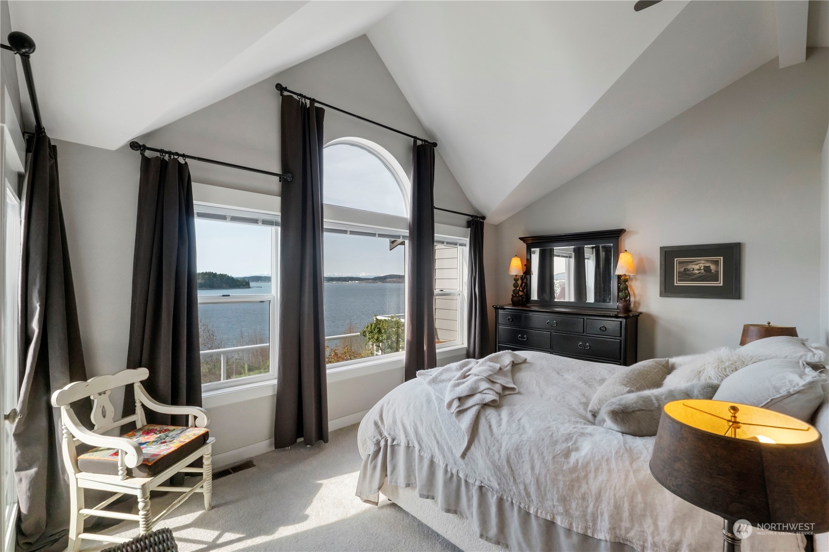 52 Chapman Loop, Unit C Steilacoom, WA 98388 - Photo 29 of 40 a bedroom with a bed and a mirror