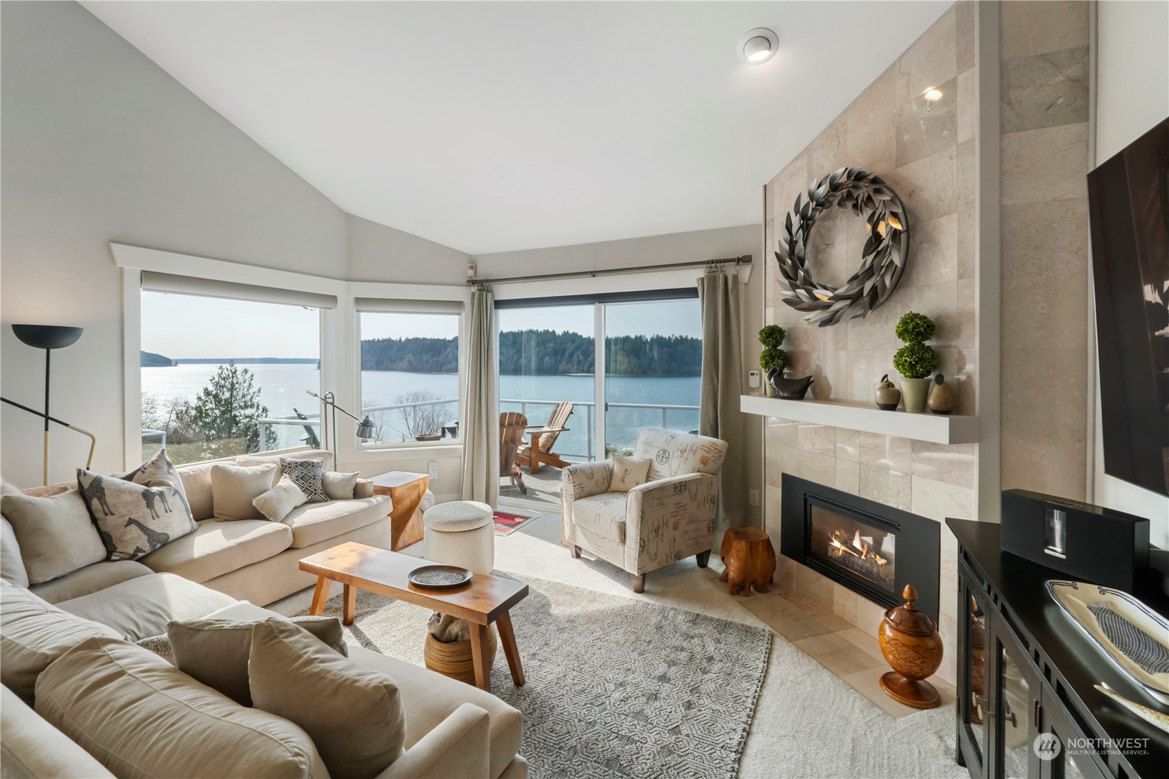 52 Chapman Loop, Unit C Steilacoom, WA 98388 - Photo 8 of 40 a living room with furniture a fireplace and a floor to ceiling window