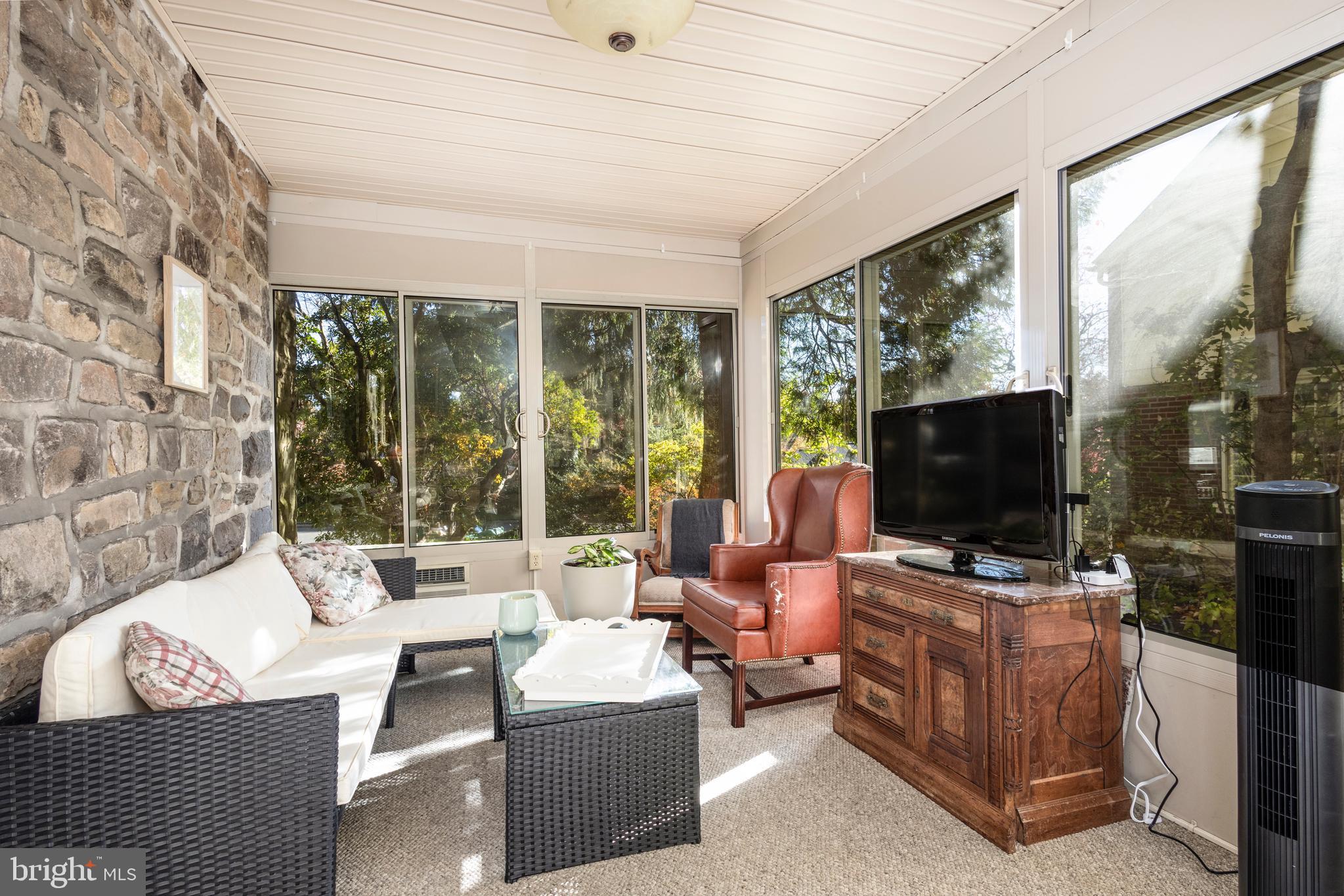 516 Beaver Road Glenside, PA 19038 - Photo 13 of 39 a living room with furniture a flat screen tv and a floor to ceiling window