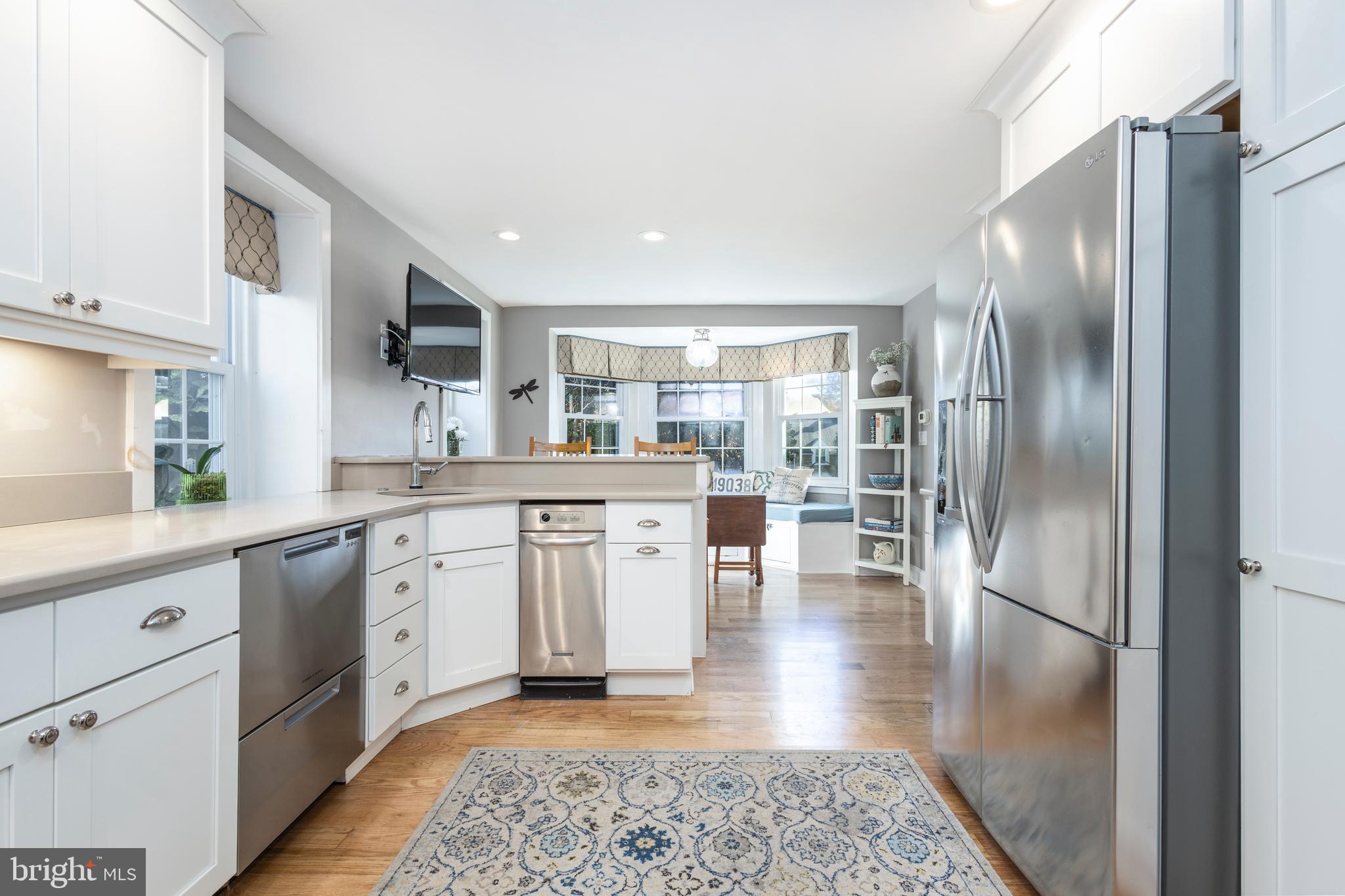 516 Beaver Road Glenside, PA 19038 - Photo 7 of 39 a kitchen with stainless steel appliances granite countertop a refrigerator a sink a stove and white cabinets