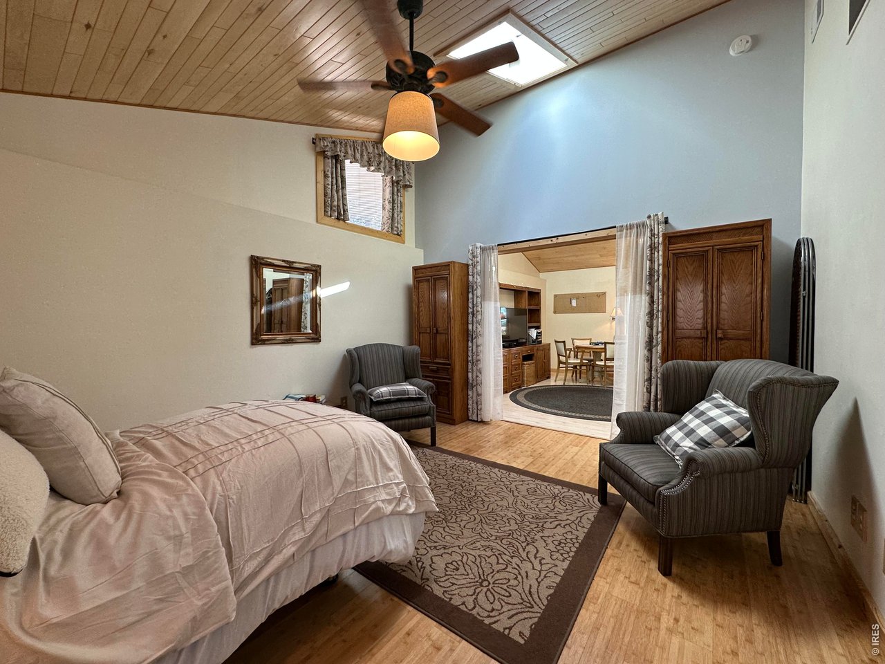 123 Mohawk Road Lyons, CO 80540 - Photo 23 of 35 a bedroom with a bed couch and a ceiling fan
