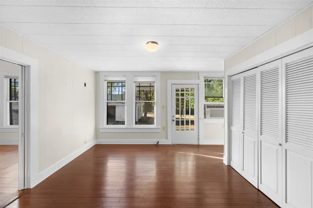 a view of utility room with closet and wooden floor