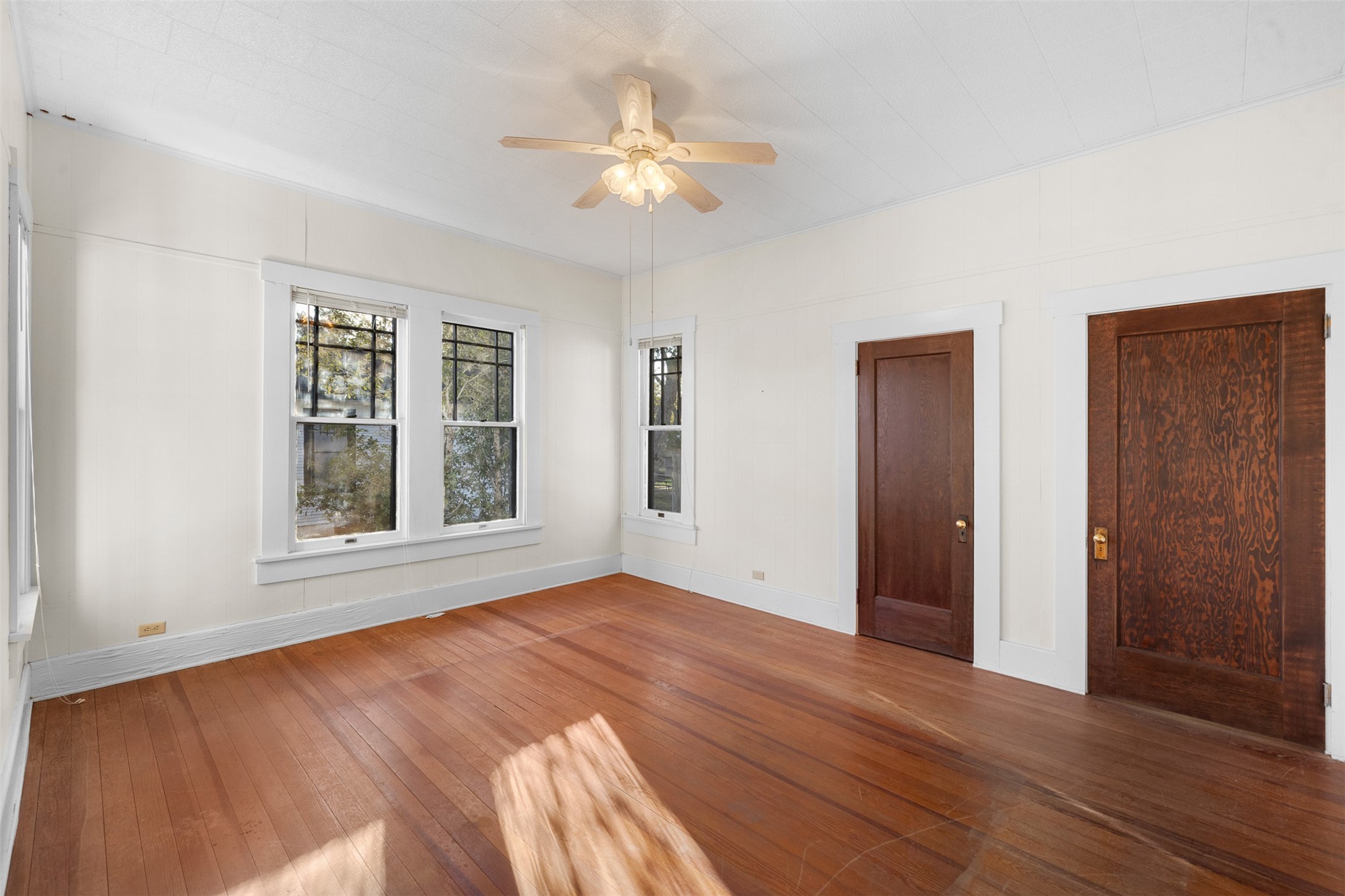 208 Summit Street Schulenburg, TX 78956 - Photo 17 of 26 a view of an empty room with wooden floor and a window