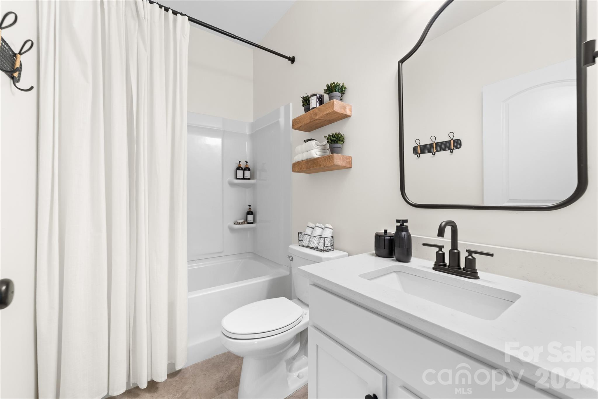 17549 Julees Walk Lane Davidson, NC 28036 - Photo 15 of 48 a bathroom with a sink a toilet and shower curtain