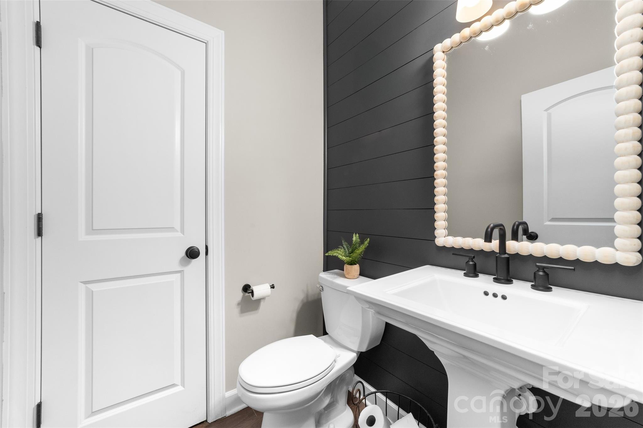 17549 Julees Walk Lane Davidson, NC 28036 - Photo 17 of 48 a bathroom with a toilet a sink and a mirror