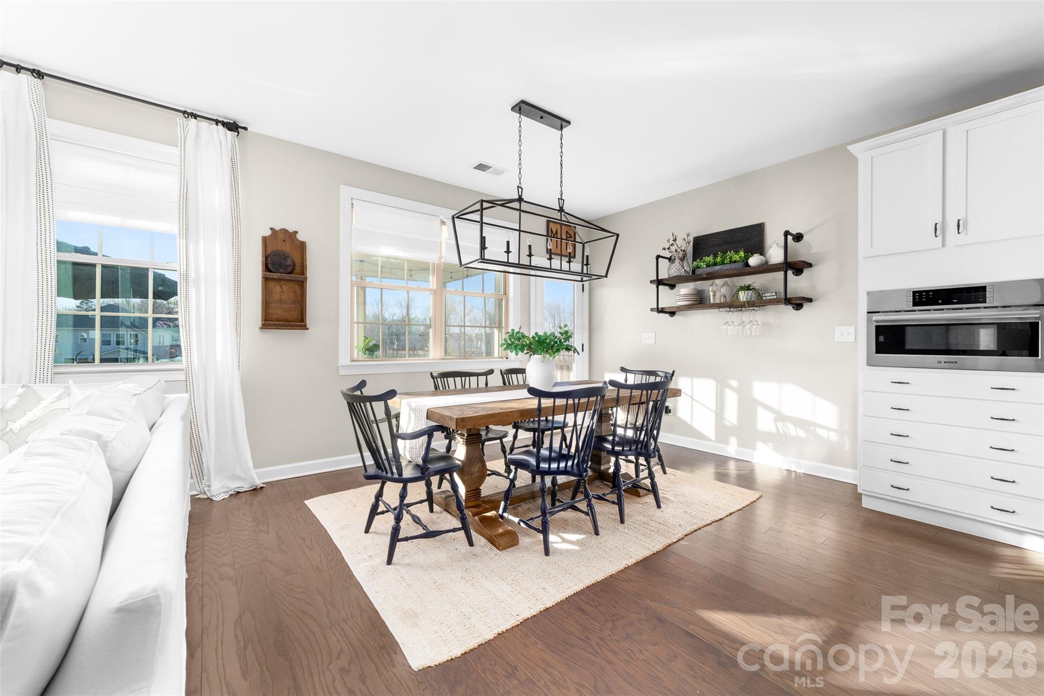 17549 Julees Walk Lane Davidson, NC 28036 - Photo 18 of 48 a view of a dining room with furniture window and wooden floor