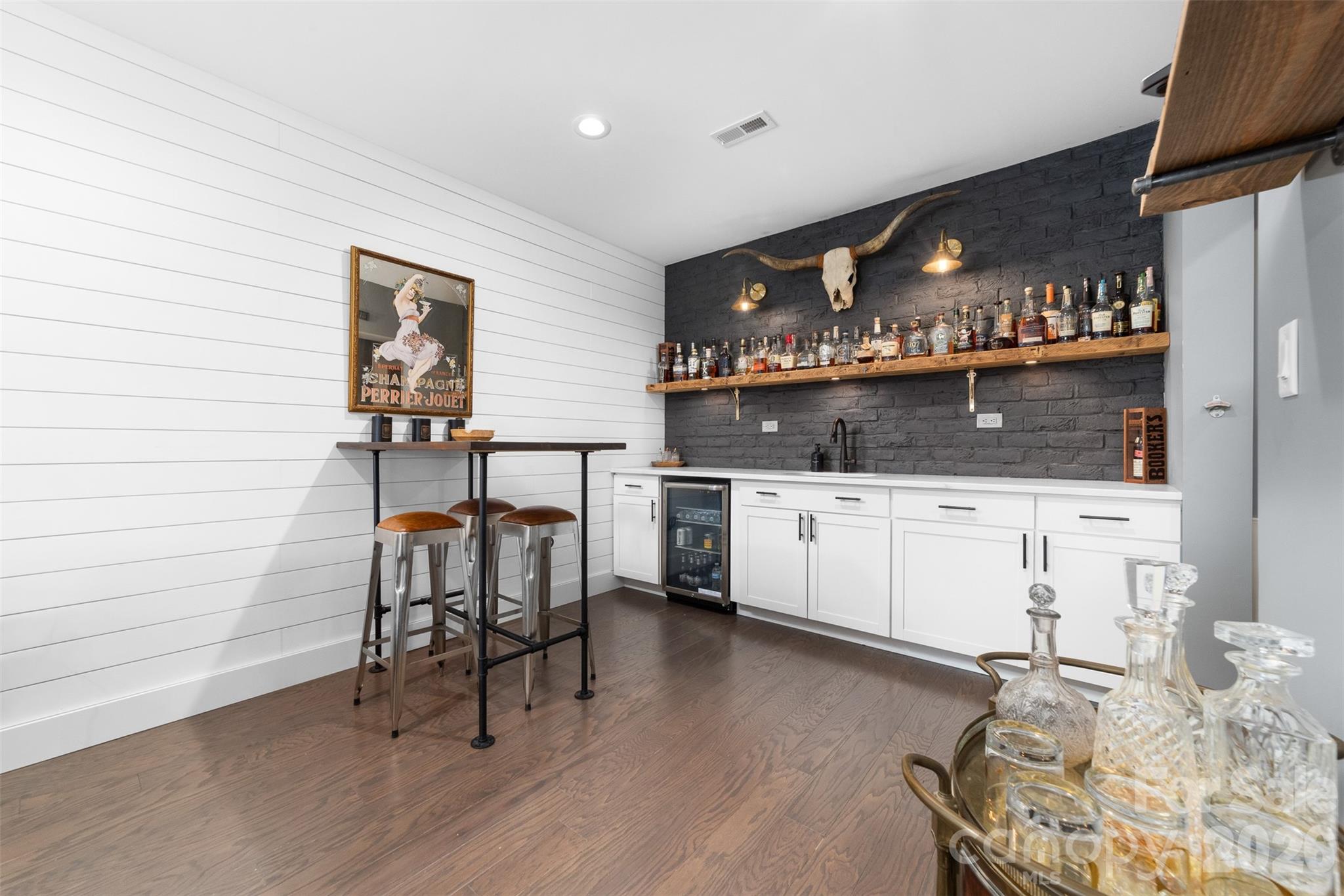 17549 Julees Walk Lane Davidson, NC 28036 - Photo 21 of 48 a kitchen with granite countertop white cabinets and chairs