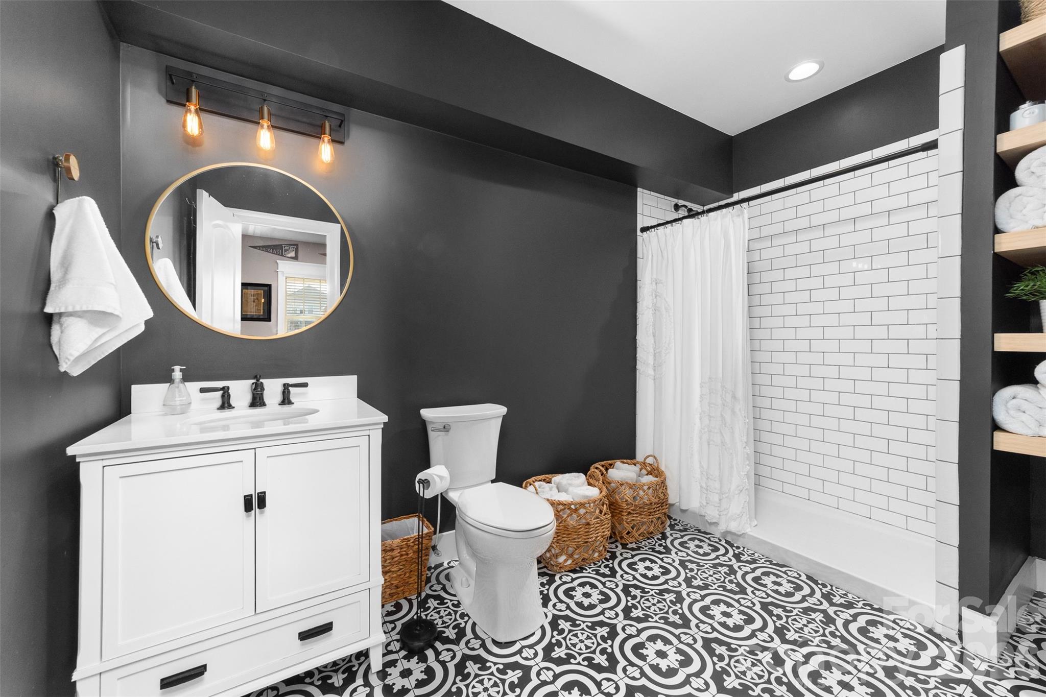 17549 Julees Walk Lane Davidson, NC 28036 - Photo 25 of 48 a bathroom with a toilet a sink and a mirror