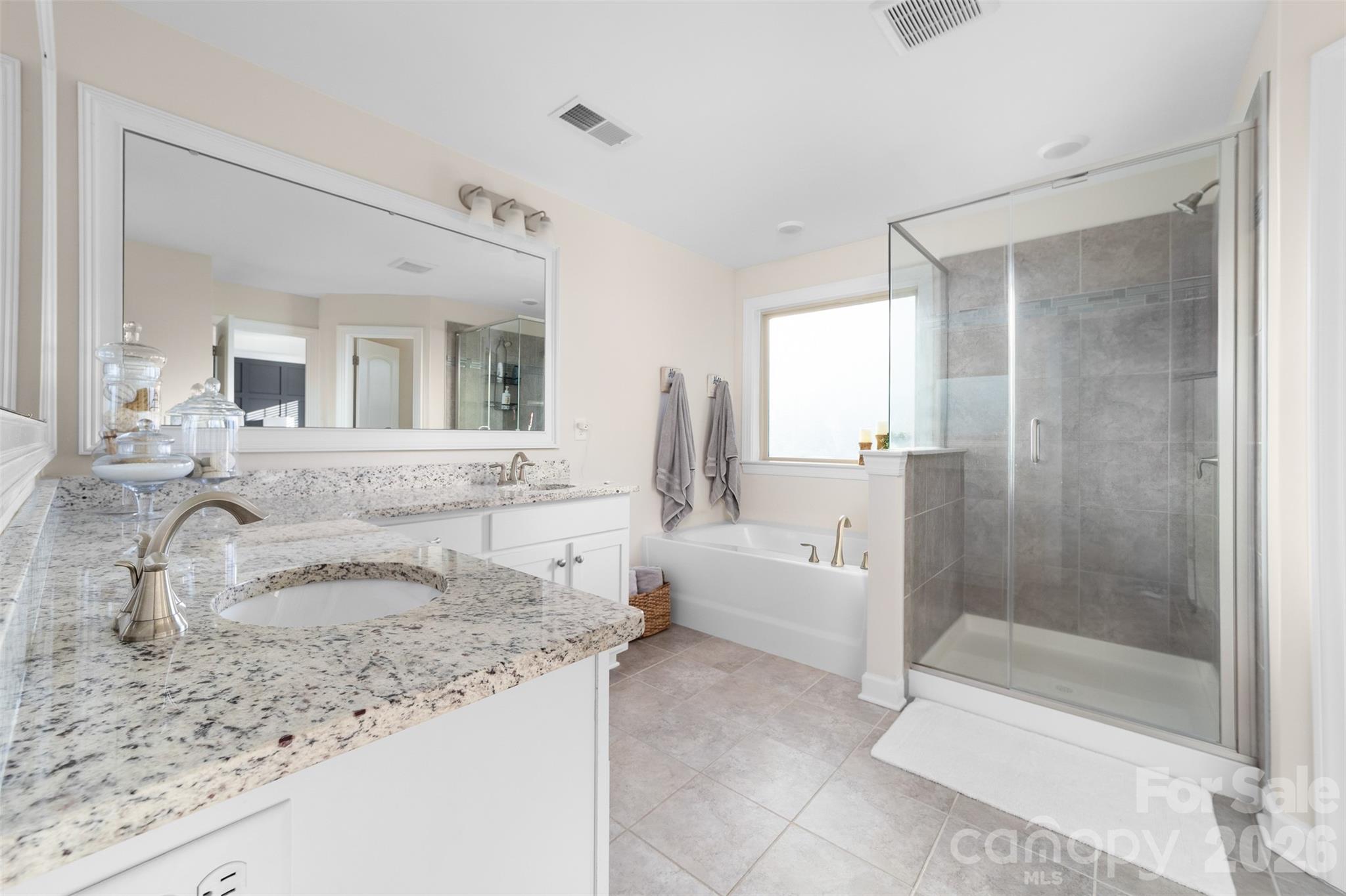17549 Julees Walk Lane Davidson, NC 28036 - Photo 36 of 48 a bathroom with a granite countertop sink mirror and bathtub
