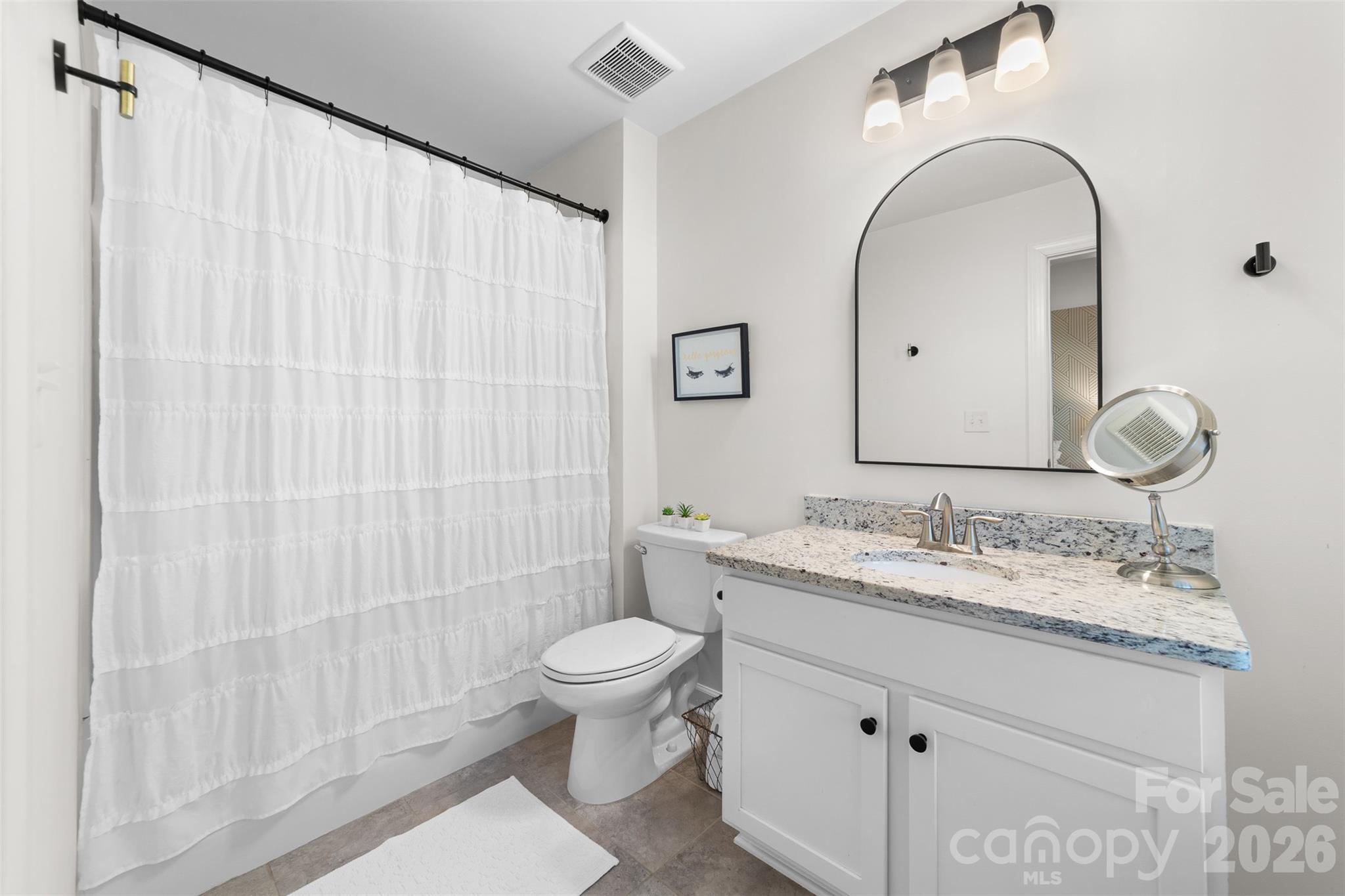 17549 Julees Walk Lane Davidson, NC 28036 - Photo 42 of 48 a bathroom with a granite countertop sink a toilet and a mirror