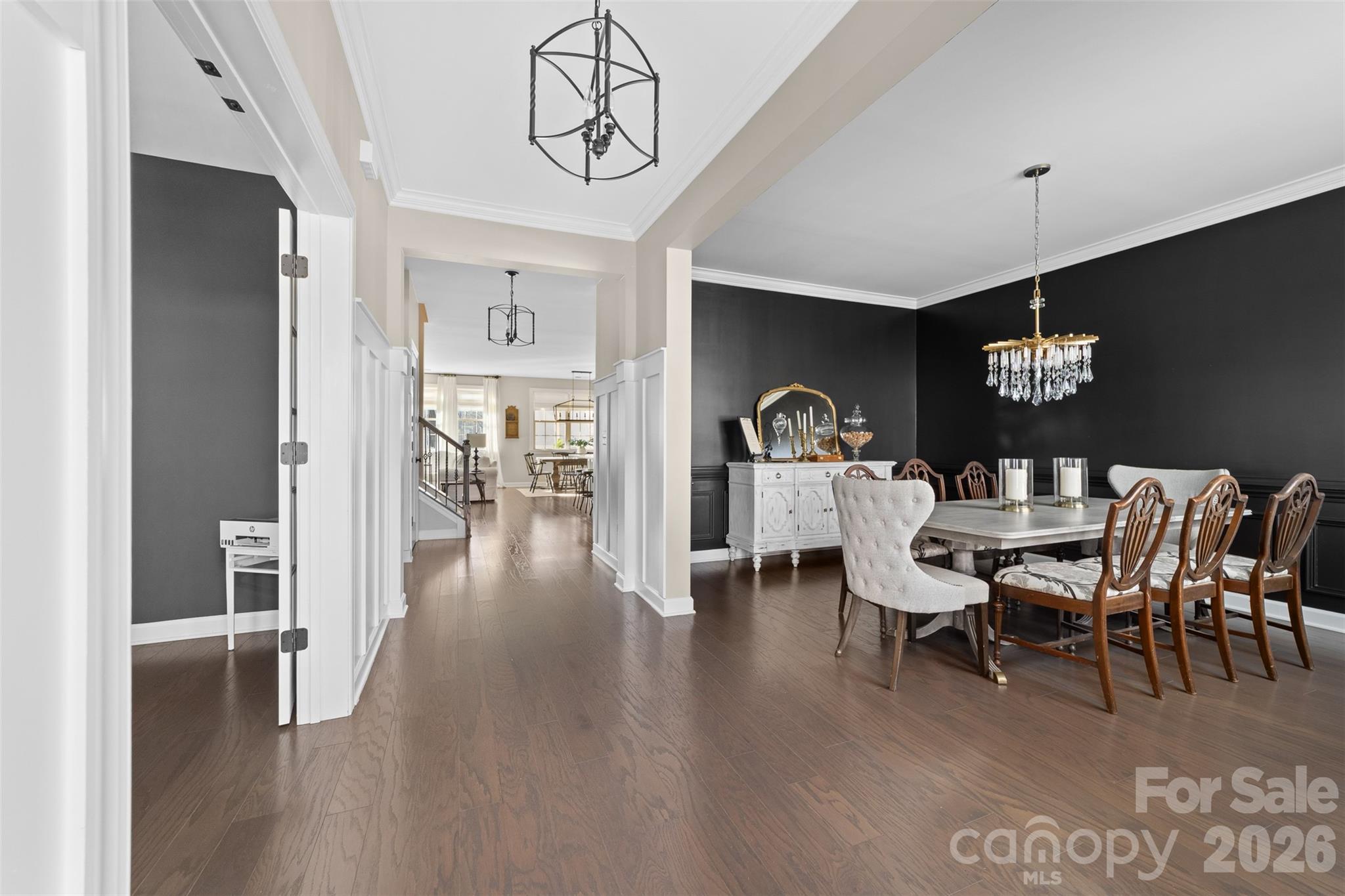 17549 Julees Walk Lane Davidson, NC 28036 - Photo 7 of 48 a dining room with furniture a chandelier and wooden floor