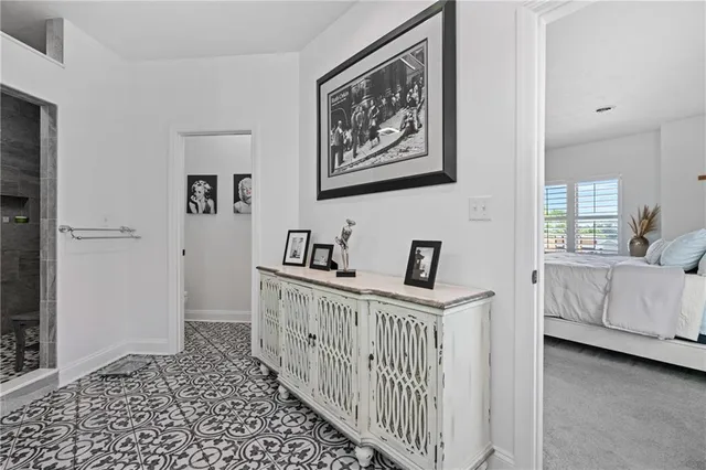a view of a hallway with bedroom and windows