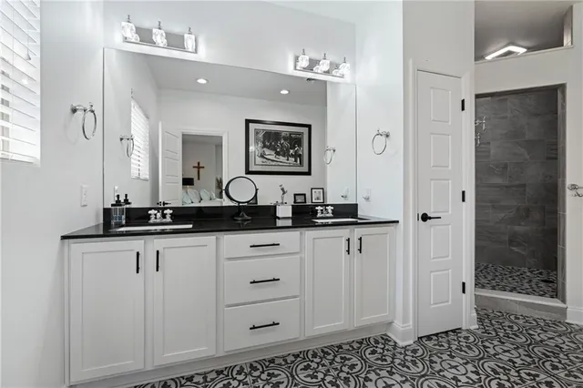 a bathroom with a sink a vanity and a mirror