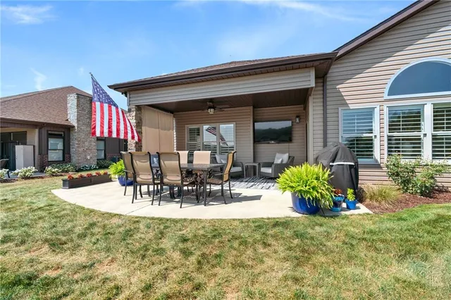a view of a patio with table and chairs and potted plants