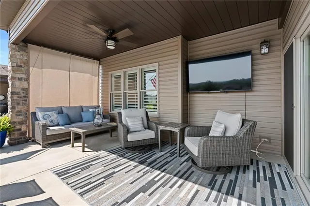 a balcony with furniture and wooden floor