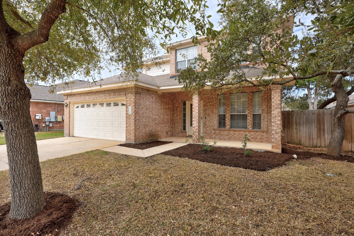 a front view of a house with a yard and garage