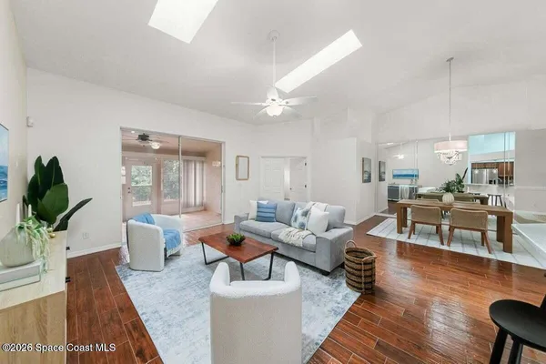 a living room with furniture and wooden floor