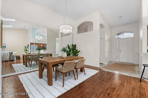 a view of a dining room with furniture and wooden floor