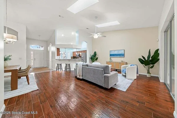 a living room with furniture and a wooden floor