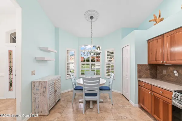 a dining room with furniture and window