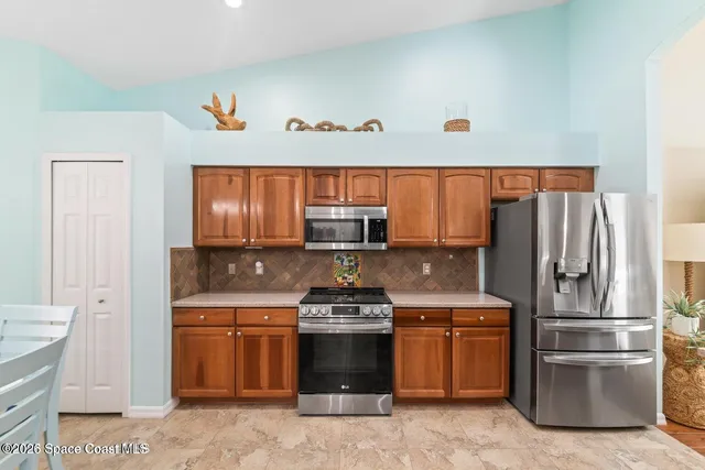 a kitchen with a stove and a refrigerator