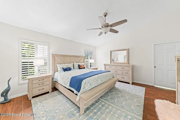 a spacious bedroom with a bed and a chandelier