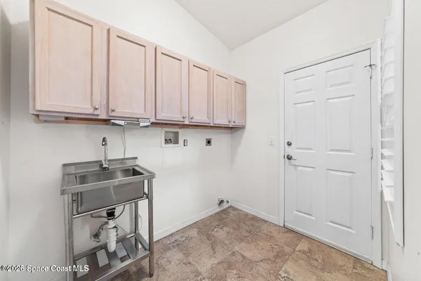 a view of kitchen with white cabinets