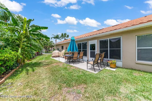a view of a backyard with sitting area and slide
